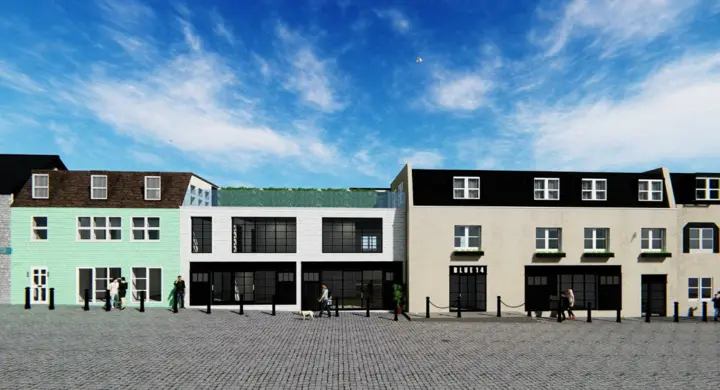 A render of the three adjoining Yolk House East buildings in a street view against a blue sky, with pedestrians passing by.